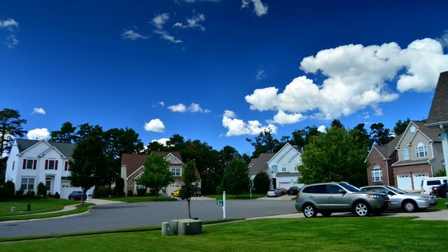 Time lapse of idyllic suburbs and rolling cumulus clouds