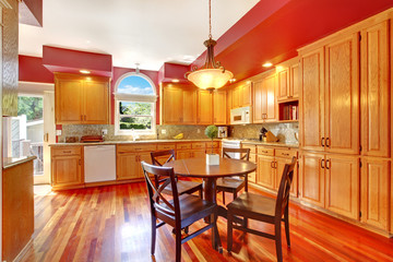 Red beautiful large kitchen with cherry hardwood.