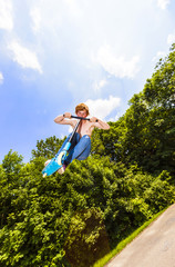 young boy going airborne with a scooter