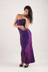 Portrait of sensual brunette caucasian woman with purple dress.