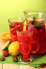 sangria in jar and glasses with fruits,