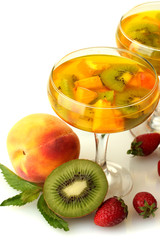 punch in glasses with fruits, isolated on white