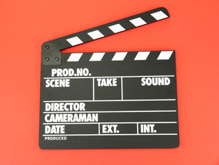 Fototapeta premium Movie production clapper board on color background