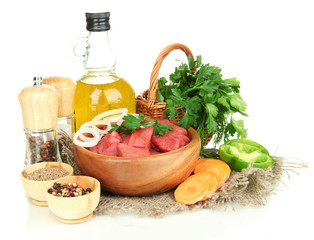 Raw beef meat in bowl with herbs, spices and cooking oil