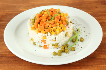 Risotto on plate on wooden background