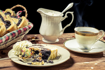 Closeup of a poppy seed cake served with hot coffee