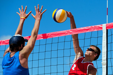 Beach volleyball tournament - attack and block - obrazy, fototapety, plakaty