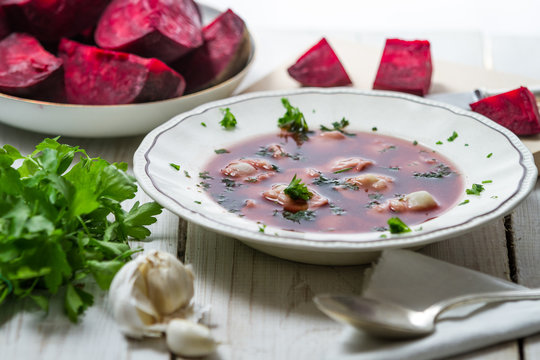 Close-up of borscht with dumplings and ingredients