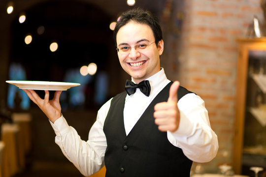Positive waiter in an elegant restaurant
