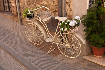 An old white bike on the street