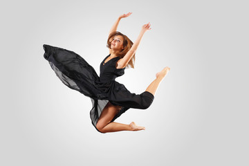 Naklejka premium Young female dancer jumping