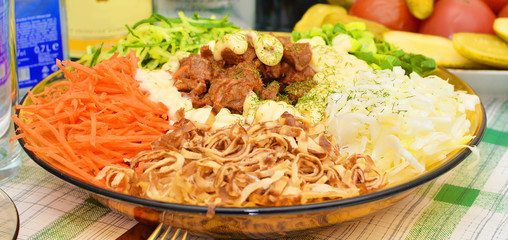 salad with cucumber carrots meat and mayonnaise