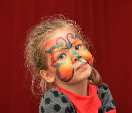 little girl painted face as butterfly