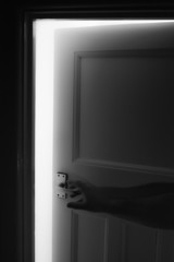 A male hand opens a door - burglar / prowler / abuse