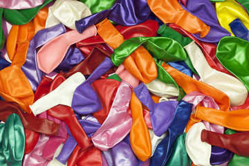 Different colored balloons stacked in pile