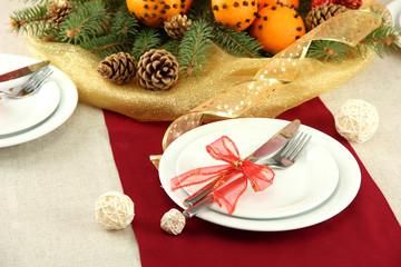 beautiful christmas table setting with tangerines and fir tree,