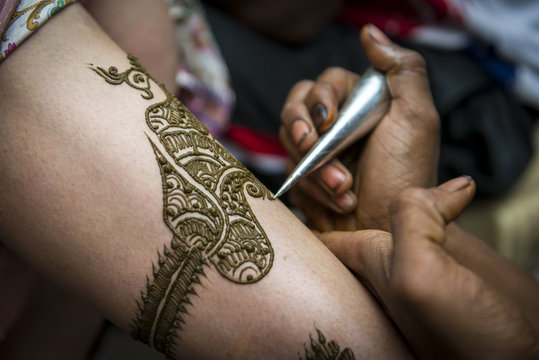 Image detail of henna being applied to arm