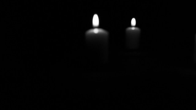 blurred burning candles. Stabilized  black & white  video