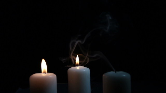Flame of three candles and smoke