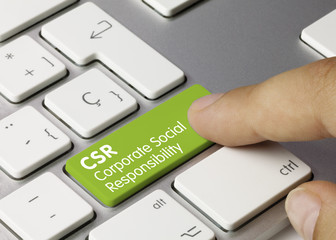 CSR Corporate social responsibility keyboard key. Finger