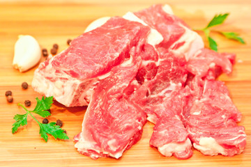 Raw beef with spices and vegetables on the cutting board