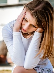 Young woman with headache outdoor