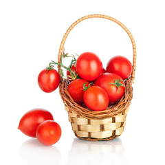 Cherry tomatoes in a basket, isolated on white