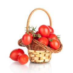 Fototapeta na wymiar Cherry tomatoes in a basket, isolated on white
