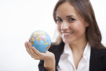 Cute business woman holding a world globe in her hand