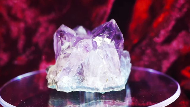 Beautiful amethyst gem rotating on a demonstration stand