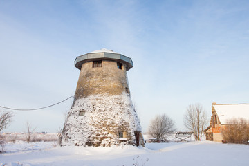 truncated windmill, a house and snow