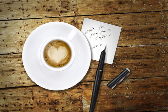Heart coffee, with pen and notes, whait for you for a coffee