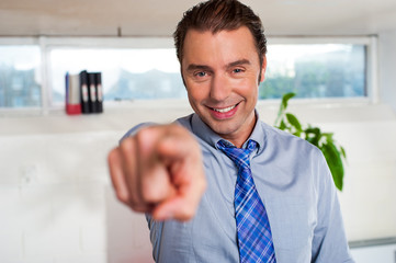 Fototapeta premium Handsome man in formals pointing at you