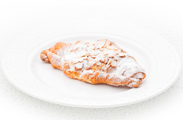 Croissant with almond on a white background