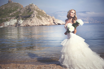 Portrait of young beautiful smiling female over blue lake water