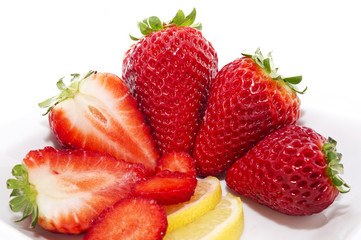 Strawberries and Lemmon in white plate