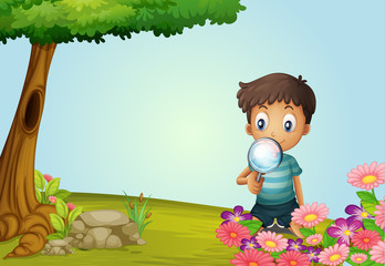 Fototapeta premium A boy with lense in garden