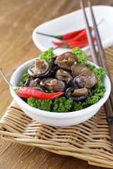 Chinese fried shiitake mushrooms in a bowl with parsley © Olga Kriger