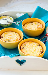 Three portions of ricotta  cheese cakes with raisins on a tray
