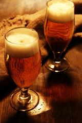 Glasses of beer on wooden table close-up