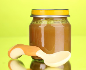 Useful and tasty baby food with beige small spoon