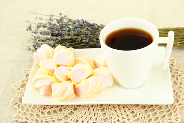 Marshmallows on plate on light background