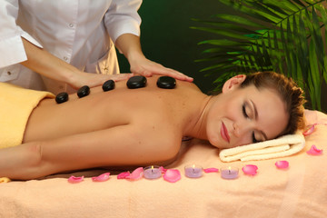 Fototapeta na wymiar beautiful young woman in spa salon getting massage with spa