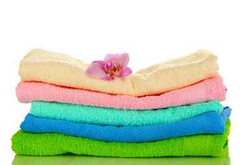 Stack of towels with fragrant flower isolated on white