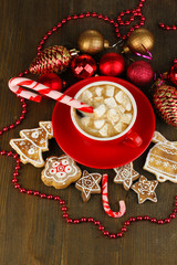 Cup of coffee with Christmas sweetness on wooden table close-up