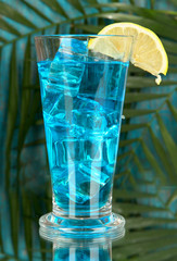 Blue Lagoon cocktail on  tropical background
