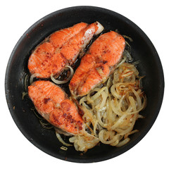 Salmon steak and onion at the pan