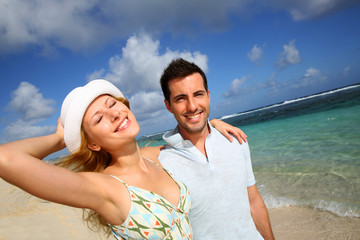 Young couple walking on a sandy beach