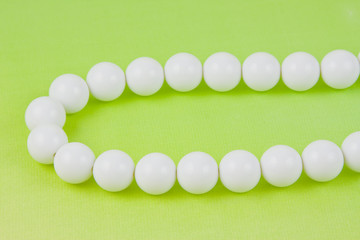 woman white beads on a light green background