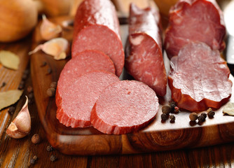 Sausage and spices on a brown table